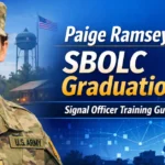Female Army officer in uniform with Army Signal Corps insignia and communications tower representing Paige Ramsey SBOLC graduation and Signal Officer training.