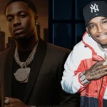 Trapboy Freddy net worth showcase featuring Dallas rapper with luxury jewelry chains and designer accessories against urban skyline backdrop